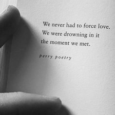 a hand holding an open book with the words we never had to force love, we were drawing in it