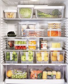 an open refrigerator filled with lots of different types of vegetables and fruit in plastic containers