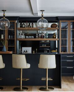 two bar stools sit in front of the bar