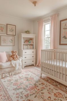 a baby's room with white furniture and pink curtains