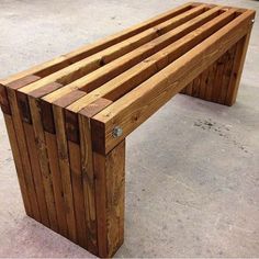 a wooden bench sitting on top of cement