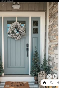 a blue front door with a wreath on it