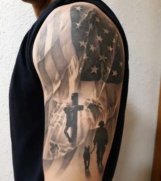 a man with a cross and american flag tattoo on his arm