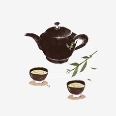 a tea pot and two cups with green leaves