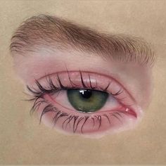 an eye with long lashes and green eyes