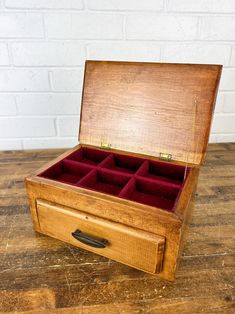 an open wooden box with several compartments