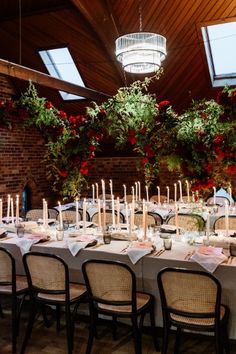 a long table is set up with candles and centerpieces for an elegant dinner