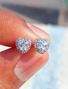 ✦ 𝐈𝐭𝐞𝐦 𝐃𝐞𝐭𝐚𝐢𝐥𝐬 Heart Cut Halo Stud Earrings, Moissanite Heart Cut Studs, Wedding Earrings For Women, 10K Gold & Silver Studs, Bridesmaid Gifts ▪️𝐌𝐞𝐭𝐚𝐥: ► Solid 10K Yellow/White/Rose Gold ► Solid 925 Sterling Silver  ► Rhodium Plated  ▪️𝐒𝐢𝐦𝐮𝐥𝐚𝐭𝐞𝐝 𝐃𝐢𝐚𝐦𝐨𝐧𝐝 𝐃𝐞𝐭𝐚𝐢𝐥𝐬: ► Color: D/White ► Clarity: VVS1 ► Stone Shape: Heart Cut & Round Cut ► Center Stone Weight: 0.50 Ct (Each) ► Total Carat Weight: 1.20 Ct  ▪️𝐌𝐨𝐢𝐬𝐬𝐚𝐧𝐢𝐭𝐞 𝐃𝐞𝐭𝐚𝐢𝐥𝐬: ► Color: Near Colorl Pear-shaped Halo Bridal Earrings For Anniversary, Pear-shaped Halo Design Bridal Earrings For Anniversary, Heart-shaped Halo Design Earrings For Gift, Heart Cut Halo Earrings For Gift, Heart Cut Halo Design Earrings For Gift, Valentine's Day Heart Cut Diamond Earrings With Prong Setting, Diamond White Heart Earrings With Prong Setting For Anniversary, Round Halo Design Jewelry For Valentine's Day, Heart-shaped Halo Earrings In Fine Jewelry Style