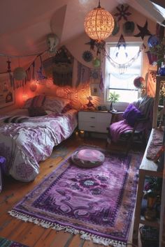 an attic bedroom with two beds, purple rugs and hanging lights on the ceiling