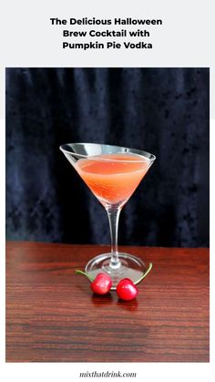 the delicious halloween drink is served in a martini glass with two cherries on the side