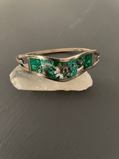 Sterling silver bangle with latch Stamped Taxco Mexico  Inlaid abalone flower and petals with crushed malachite background  6.75" on the bracelet mandrel  Great vintage condition Vintage Clothing & Jewelry with a Southwest Flair Check out my shop for more jewelry and clothing! https://sierramadrevintage.etsy.com Taxco Malachite Inlay Bangle | Mexican Silver Bangle | vintage abalone malachite bracelet Vintage Malachite Jewelry Gift, Vintage Malachite Jewelry For Gifts, Elegant Green Jewelry With Inlay, Vintage Abalone Shell Jewelry Gift, Handmade Vintage Abalone Shell Jewelry, Vintage Abalone Shell Jewelry As A Gift, Vintage Abalone Shell Jewelry For Gift, Vintage Green Sterling Silver Bracelets, Vintage Silver Abalone Shell Jewelry