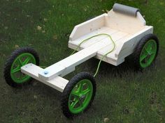 a wooden wagon with green wheels on the grass