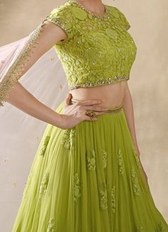 Elegance meets vibrant charm in this exquisite Lime Green Embroidered Net Lehenga Set, designed to make a captivating statement. Crafted from soft net fabric, the flowy lime green lehenga features delicate gathers at the waist, adorned with scattered floral embroidery crafted from shimmering sequins and intricate threadwork, adding a touch of opulence to every twirl. Paired with a matching blouse, the design flaunts a sweetheart neckline and a sheer back that strikes the perfect balance between Lime Green Lehenga, Matching Embroidery, Cutwork Lace, Indian Kurti Designs, Net Skirt, Add Sleeves, Green Lehenga, Cap Sleeves Blouse, Lehenga Skirt