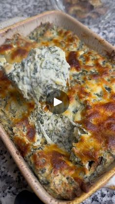 a casserole dish with spinach and cheese