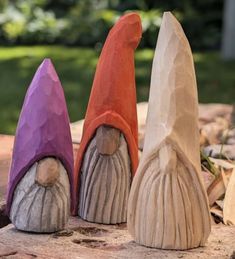 three gnomes made out of clay sitting next to each other on top of a rock