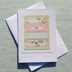 two cards with birds and flowers on them, one is folded to show the same pattern