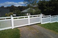 a white picket fence in front of a house