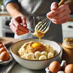 a person is whisking an egg over mashed potatoes in a white bowl