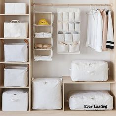 an organized closet with white linens and clothes