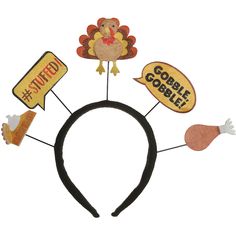 a black headband with turkeys and goodie signs on the front, along with other thanksgiving decorations