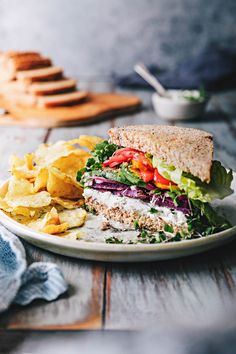 a white plate topped with a sandwich and chips