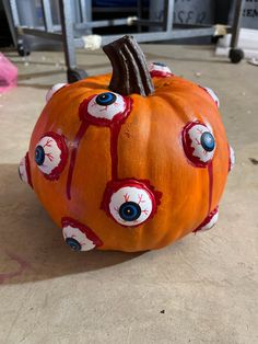 an orange pumpkin with eyes painted on it