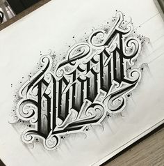 a drawing of the word tattoo written in cursive writing on paper with ink