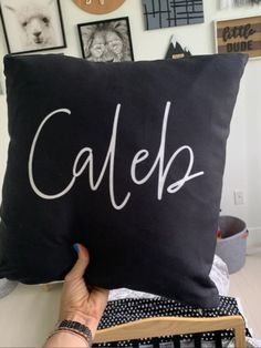 someone holding up a pillow with the word calep on it