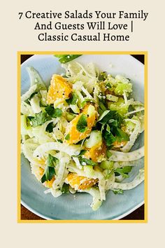 a white plate topped with cabbage and oranges next to a yellow frame on top of a wooden table