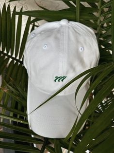 "Our 777 hat is one of our first embroidered product designs. This one's got a low profile with an adjustable strap and curved visor. -100% chino cotton twill -Unstructured, 6-panel, low-profile -6 embroidered eyelets -3 ⅛\" (7.6 cm) crown -Adjustable strap with antique buckle This product is made especially for you as soon as you place an order, which is why it takes us a bit longer to deliver it to you. Making products on demand instead of in bulk helps reduce overproduction, so thank you for Angel Number 777, Golf Hat, Golf Hats, Angel Number, Spiritual Gifts, Dad Hat, Unisex Style, St Patricks, Trucker Cap