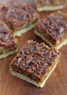 several pieces of pecan bar sitting on top of a wooden table