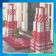 christmas presents are stacked on top of each other in front of a house with snow