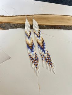 Very long narrow American style earrings. Made from Czech beads. Length 8 inches (20cm). Width 0.5inch(1.5cm) Hypoallergenic clasp. If you want these earrings in a different color, write to me and I will be happy to make them for you. White Long Drop Earrings With Colorful Beads, Long Drop Beaded Earrings, White Beaded Long Drop Earrings, White Long Drop Earrings With Ear Wire, White Long Drop Ear Wire Jewelry, White Long Drop Earrings With Dangling Beads, Long Beaded Earrings, Earrings Native American, Native American Earrings