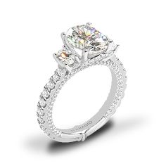 a three stone engagement ring with diamonds on it