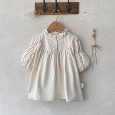 Cream Cotton Bubble Romper With Short Sleeves, Cream Cotton Bubble Romper For Playtime, Cream Cotton Playtime Bubble Romper, Cotton Bubble Romper With Short Sleeves For Baptism, Cute Cream Cotton Bubble Romper, Cute Long Sleeve Cream Bubble Romper, Cute Cream Dress With Doll Collar, Sweet Cream Short Sleeve Dress, Cream Long Sleeve Bubble Romper For Summer