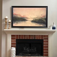 a fire place with a painting on the mantle