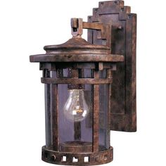 an old fashioned wall light with three lights on it