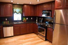 a kitchen with wooden cabinets and stainless steel appliances