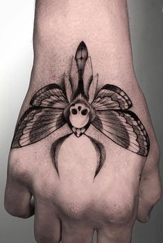 a hand with a bird tattoo on it