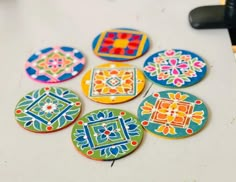 six decorated cookies sitting on top of a table