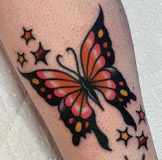 a colorful butterfly with stars on it's back leg and arm tattoo designs for women