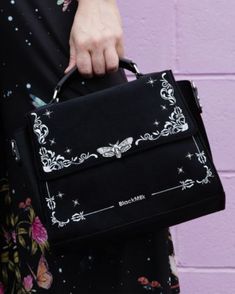 The perfect new handbag just dropped! Gorgeous black velvet fabric, with silver embroidered filigree & stars and a metal Death's Head Hawkmoth front and centre (as it should be).

It comes with a detachable shoulder strap, as well as the top strap for easy and versatile carrying and a magnetic closure to keep all your goodies safe. This bag is the perfect everyday size and we have no doubt it will be your new go-to.