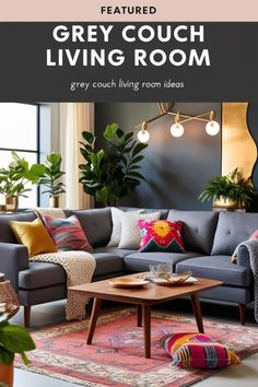 a living room with grey couches, colorful pillows and rugs on the floor