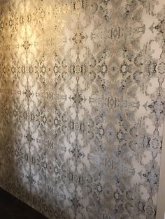 the wall is covered in an intricately designed pattern and has been painted with metallic paint