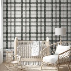 a baby's room with plaid wallpaper and rocking chair