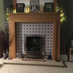 a living room with a fireplace and pictures on the mantle