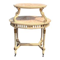 an ornately decorated table with marble top and two tiered trays on wheels