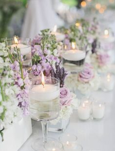 the table is set with candles and flowers