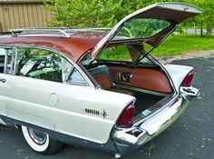 an old white car with its trunk open