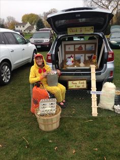 a woman sitting in the back of a truck filled with chickens and other things to eat